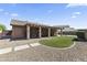 Beautiful backyard featuring a covered patio, manicured lawn, and desert landscaping at 10747 W Via Del Sol --, Peoria, AZ 85373
