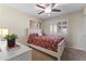 Cozy bedroom features a comfortable bed with a patterned duvet, shuttered windows, and soft carpeting at 10747 W Via Del Sol --, Peoria, AZ 85373