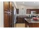 Close-up of kitchen with stainless steel refrigerator and appliances, granite countertops, and rich, dark wood cabinetry at 10747 W Via Del Sol --, Peoria, AZ 85373