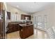 Bright kitchen with stainless steel appliances, granite countertops, dark wood cabinets, and access to the backyard and pool at 10747 W Via Del Sol --, Peoria, AZ 85373