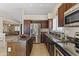 Well-equipped kitchen boasts stainless steel appliances, granite countertops, and wood cabinets at 10747 W Via Del Sol --, Peoria, AZ 85373