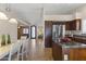 Open kitchen featuring stainless steel appliances, a center island, and seamlessly connecting to the dining and living areas at 10747 W Via Del Sol --, Peoria, AZ 85373