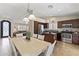 Open-concept kitchen view shows dining table, stainless appliances and living room at 10747 W Via Del Sol --, Peoria, AZ 85373
