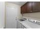 Convenient laundry room with modern washer and dryer and overhead storage cabinets at 10747 W Via Del Sol --, Peoria, AZ 85373