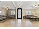 Bright living room featuring tile floors, ceiling fans, and an ornate wrought iron front door at 10747 W Via Del Sol --, Peoria, AZ 85373