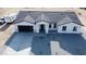 Aerial view of new construction featuring a neutral colored stucco, gray roof, and modern garage door at 11798 S 216Th Ave, Buckeye, AZ 85326