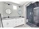 Modern bathroom featuring a double vanity, granite countertop, and a luxurious glass-enclosed shower with black tile at 11798 S 216Th Ave, Buckeye, AZ 85326