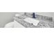Close-up on a bathroom sink with a granite countertop and a matte black faucet at 11798 S 216Th Ave, Buckeye, AZ 85326