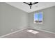 Empty bedroom featuring a ceiling fan and a large window that brings in natural light at 11798 S 216Th Ave, Buckeye, AZ 85326