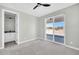 Bedroom with a ceiling fan, and access to a private bathroom and sliding glass doors at 11798 S 216Th Ave, Buckeye, AZ 85326