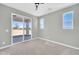 Spacious bedroom with windows and a sliding glass door leading to the outside at 11798 S 216Th Ave, Buckeye, AZ 85326
