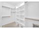 Bright, open walk-in closet with custom shelving and clothing rods at 11798 S 216Th Ave, Buckeye, AZ 85326