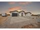 Lovely one-story home with a black garage door, concrete driveway and minimalist desert landscaping at 11798 S 216Th Ave, Buckeye, AZ 85326