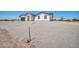 View of the exterior of a new construction home with gravel yard at 11798 S 216Th Ave, Buckeye, AZ 85326