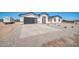 New construction home featuring a modern gray garage door and concrete driveway at 11798 S 216Th Ave, Buckeye, AZ 85326