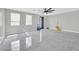 Open living space with ceiling fan, tile floors and many windows at 11798 S 216Th Ave, Buckeye, AZ 85326