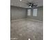 Large, tiled living room area with neutral walls and recessed lighting at 11798 S 216Th Ave, Buckeye, AZ 85326