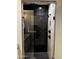 Luxury shower with black marble, a rain shower head, and glass door at 11798 S 216Th Ave, Buckeye, AZ 85326