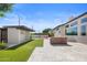 Expansive backyard featuring manicured lawn, a modern pool, patio area, and chic outdoor furniture at 1249 E Desert Park Ln, Phoenix, AZ 85020