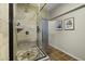Elegant bathroom featuring a glass shower enclosure and decorative tile flooring at 1249 E Desert Park Ln, Phoenix, AZ 85020