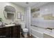 Full bathroom with a vintage vanity, mirror, and shower-tub combo at 1249 E Desert Park Ln, Phoenix, AZ 85020