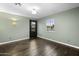 Bedroom with hardwood floors, a black door, and a window with natural light at 1249 E Desert Park Ln, Phoenix, AZ 85020