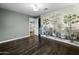 Bedroom featuring hardwood floors, a tropical mural wall and an open door to the kitchen at 1249 E Desert Park Ln, Phoenix, AZ 85020