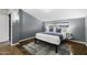 Comfortable bedroom featuring a cozy rug, window view, and stylish gray accent wall at 1249 E Desert Park Ln, Phoenix, AZ 85020