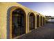 Arched exterior courtyard featuring brick floors, black metal gates, and views of the surrounding area at 1249 E Desert Park Ln, Phoenix, AZ 85020