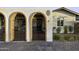 Arched entryways with wrought iron gates and brick accents, plus brick driveway at 1249 E Desert Park Ln, Phoenix, AZ 85020