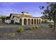 Wide exterior of home featuring a brick driveway, low bushes, and unique architectural elements at 1249 E Desert Park Ln, Phoenix, AZ 85020