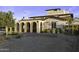 Beautiful home with arched entryways, wrought iron gates, manicured landscaping, and paved driveway at 1249 E Desert Park Ln, Phoenix, AZ 85020