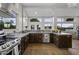 Kitchen features stainless steel appliances, wooden cabinets, and large windows at 1249 E Desert Park Ln, Phoenix, AZ 85020