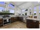 Kitchen features stainless steel appliances, wooden cabinets, and large windows at 1249 E Desert Park Ln, Phoenix, AZ 85020