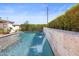 The tranquil pool boasts elegant waterfall features, complemented by lush landscaping and clear blue water at 1249 E Desert Park Ln, Phoenix, AZ 85020