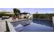 Sparkling pool surrounded by a stone patio and lush landscaping and outdoor seating at 1249 E Desert Park Ln, Phoenix, AZ 85020