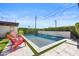Inviting pool features a modern waterfall design, surrounded by stylish patio and manicured greenery at 1249 E Desert Park Ln, Phoenix, AZ 85020