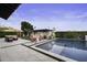 Sparkling pool surrounded by a stone patio and lush landscaping, perfect for relaxation at 1249 E Desert Park Ln, Phoenix, AZ 85020