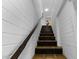 Staircase featuring painted white block walls, stained wood treads and terracotta tiled landing at 1249 E Desert Park Ln, Phoenix, AZ 85020