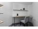 Workspace with wall shelving, wood desk and gray chair at 1249 E Desert Park Ln, Phoenix, AZ 85020