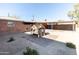 View of backyard featuring a playhouse, carport, brick wall, and desert landscaping at 1330 E Monte Vista Rd, Phoenix, AZ 85006