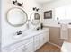 Bathroom with dual sinks, white cabinets, and decorative mirrors at 1330 E Monte Vista Rd, Phoenix, AZ 85006