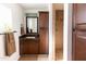 Bathroom features a brown vanity with storage, decorative mirror, and tiled shower at 1330 E Monte Vista Rd, Phoenix, AZ 85006