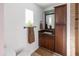 Bathroom features a brown vanity with storage, decorative mirror, and tiled shower at 1330 E Monte Vista Rd, Phoenix, AZ 85006