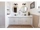 Bright bathroom featuring double sinks, round mirrors, white cabinets, and built-in shelves at 1330 E Monte Vista Rd, Phoenix, AZ 85006