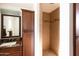 Bathroom features a brown vanity with storage, decorative mirror, and tiled shower at 1330 E Monte Vista Rd, Phoenix, AZ 85006