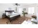 Bright bedroom with a ceiling fan, oriental rug, and two windows providing ample natural light at 1330 E Monte Vista Rd, Phoenix, AZ 85006