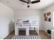 Bright bedroom with a lofted bed, gray rug, abstract artwork, and a ceiling fan at 1330 E Monte Vista Rd, Phoenix, AZ 85006