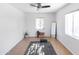 Bright exercise room featuring a large window, yoga mat, standing mirror, and a ceiling fan at 1330 E Monte Vista Rd, Phoenix, AZ 85006