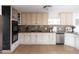 Well-lit kitchen with stainless steel dishwasher, ovens, and granite countertops at 1330 E Monte Vista Rd, Phoenix, AZ 85006